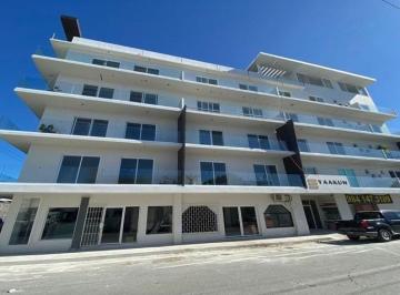 una fachada externa de un edificio con departamentos en renta y venta en yaakun condos playa del carmen · Departamento Amueblado 1 Recámara en Renta | Yaakun Condos Playa del Carmen
