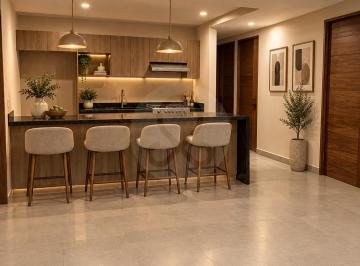 Cocina moderna cálida con isla de madera.png · Departamento en Venta en del Valle Norte