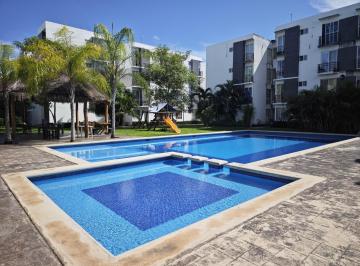 Alberca con Chapoteadero y carriles de nado · Departamento en Renta en Planta Baja en Palmas Turquesa, Playa del Carmen